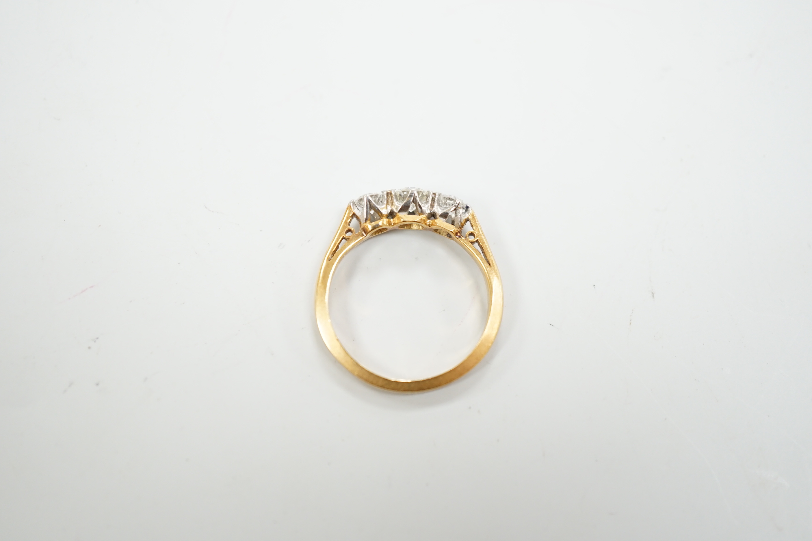 An 18ct, plat and three stone diamond set ring, size K, gross weight 2.7 grams.
